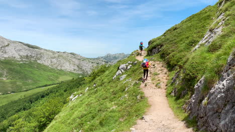 Climbers-walking-along-the-trail-on-a-summer-day-in-the-Picos-de-Europa,-Spain
