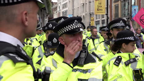 A-unit-of-Metropolitan-police-officers-stand-awaiting-orders-while-policing-an-Extinction-Rebellion-climate-change-protest
