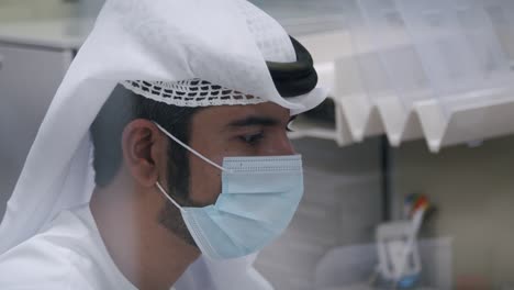 Close-Up-Of-An-Arab-Man's-Face-In-Mask-While-Working-In-The-Office-During-Pandemic