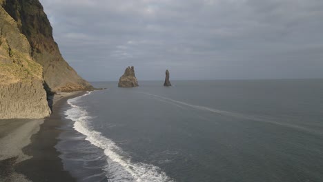 Reynisfjara-black-sand-beach-and-stacks-in-background,-Iceland
