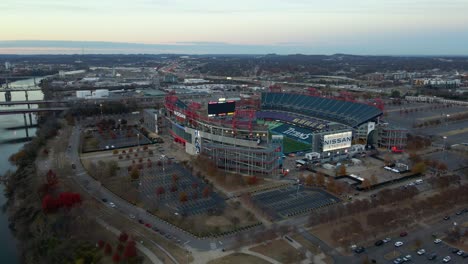 Aerial-view-of-the-Nissan-Stadium-and-the-Cumberland-river,-dusk-in-Nashville,-USA---pan,-drone-shot