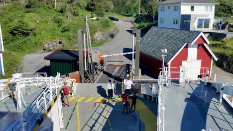 Small-ferryboat-loading-cars-and-leaving-port-at-popular-Leroy-island-south-of-Bergen---static-shot-Norway
