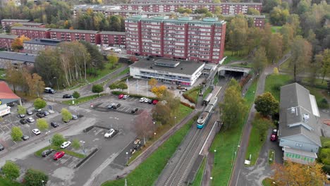 Tram-stop-at-Gärdsås-Torg,-Bergsjon,-Gothenburg-Sweden,-Aerial-Reveal