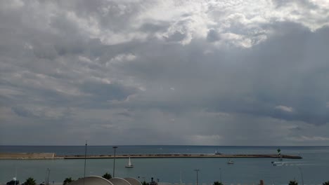 Time-lapse-of-Barcelona's-port-horizon-on-a-bright-day-with-quite-a-few-clouds-and-the-sun-shinning-behind