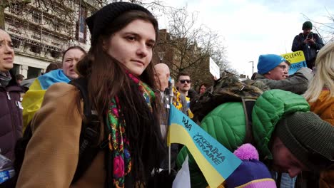 Walking-through-group-of-people-at-Ukraine-anti-war-protest-activists-on-Manchester-city-street