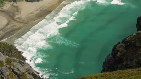 Slow-motion-of-waves-crashing-to-sand-beach-shot-from-far-away-above
