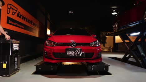 Red-Hot-rod-VW-Volkswagon-GTi-sports-car-being-lifted-onto-carjack