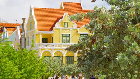 Famous-and-iconic-Penha-building-in-touristic-Handelskade,-Willemstad,-on-the-Caribbean-island-of-Curacao