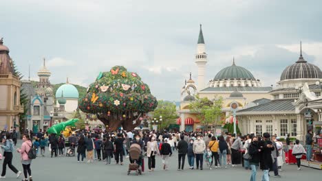 Crowds-of-happy-children-with-parents-walking-around-in-Everland-Amusement-Park-in-Yongin,-South-Korea