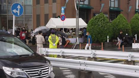 Japanese-Police-standing-in-the-rain-after-death-of-Shinzo-Abe-outside-Yamato-Saidaiji-Station