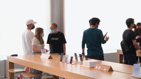 Customers-are-seen-testing-and-purchasing-Apple-brand-products-during-the-launch-day-of-the-new-iPhone-14-series-smartphones-at-the-official-Apple-store-in-Hong-Kong