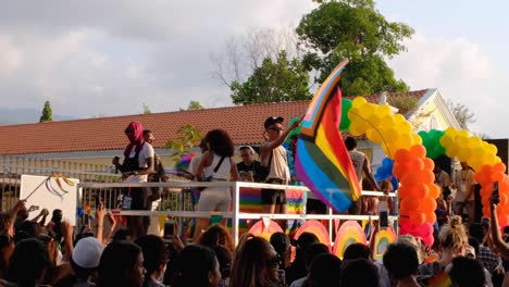 A-carnival-float-at-PRIDE-2022-of-happy,-dancing-Timorese-people-and-flag-in-the-capital-Dili,-Timor-Leste,-Southeast-Asia