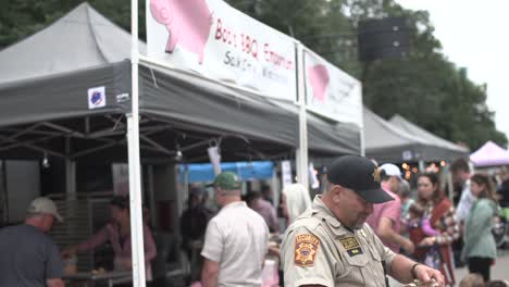Taste-of-Madison-Security-officer-and-tilt-up-to-BBQ-Pig-Sign