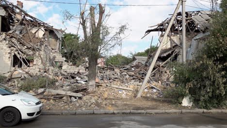 An-elderly-woman-walks-in-front-of-a-destroyed-primary-school-that-was-hit-with-a-Russian-missile-during-the-war-in-Ukraine