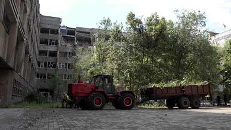 A-tractor-pulls-a-trailer-full-of-debris-removed-from-the-Admiral-Makarov-National-University-of-Ship-Building-courtyard-following-it-being-struck-with-four-Russian-missiles-during-the-Ukraine-war