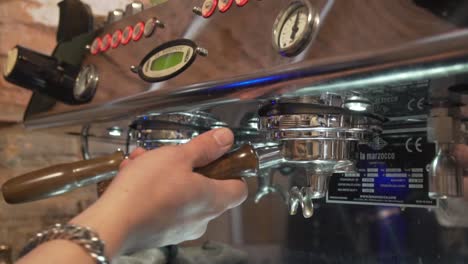 Hand-Removing-Double-Spout-Portafilter-From-Coffee-Machine