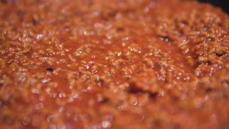 cooking-sauce-bolognese-close-up-of-minced-meat-boiling-in-pan