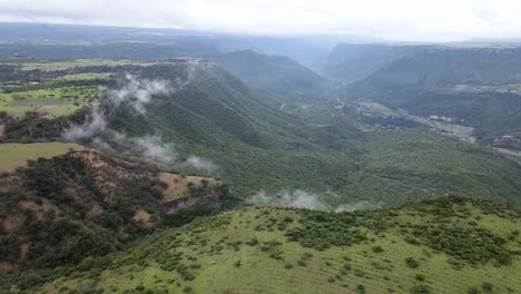 Frontal-view-of-pena-del-aire-canyon-in-a-cloud-day-with-a-drone