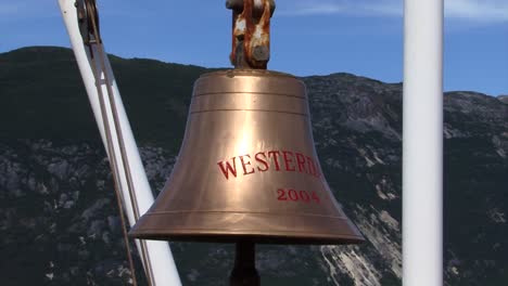 Holland-America-Line,-Westerdam's-cruise-ship-bell-in-the-bow-of-the-ship,-in-a-sunny-day-in-Alaska