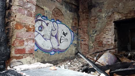 Closeup-Of-Graffiti-Sprayed-On-Brick-Wall-Of-City-Abandoned-Building,-Urban-Ruins-Exploration