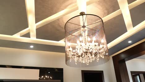 Tracking-Shot-Of-Large-Hanging-Light-Fixture-From-Ceiling