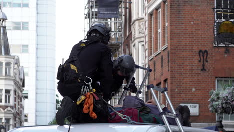 Officers-from-a-specialist-police-unit-climb-on-top-a-van-being-used-as-a-road-block-and-prepare-to-remove-two-Extinction-Rebellion-climate-change-protestors