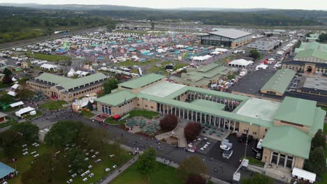 Aerial-drone-view-over-park-and-buildings-towards-the-NY-state-fair-area,-in-Syracuse,-USA