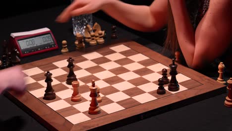 Two-unrecognizable-women-play-final-part-of-chess-game-match-and-shake-hands