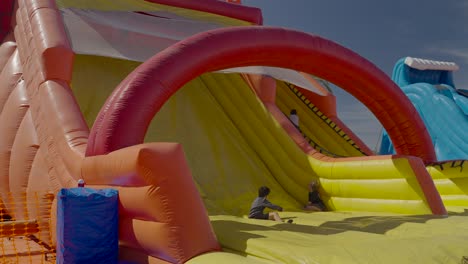 Child-sliding-down-a-large-blow-up-slide