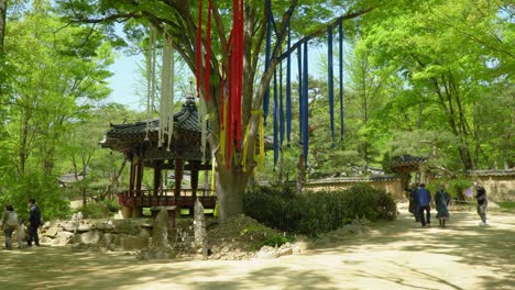 Tourists-walking-near-village-shrine-Seonangdang-At-Korean-Folk-Village-In-Yongin-Of-Gyeonggi-In-South-Korea