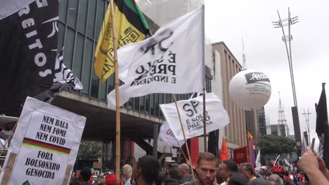 Protest-Against-President-Bolsonaro-in-Sao-Paulo,-Brazil,-Black-Consciousness-Rally,-Crowd-With-Flags,-Close-Up,-Slow-Motion