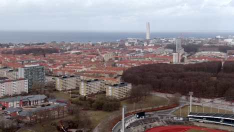 Malmo-Stadium-And-City-Buildings,-Sweden---Aerial-Reverse-Shot
