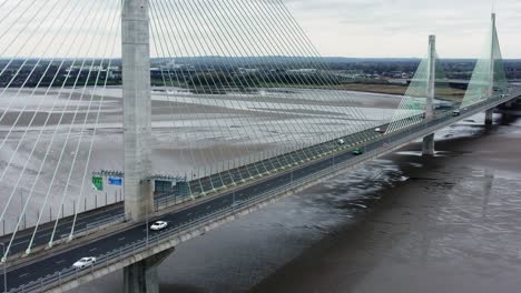 Mersey-gateway-landmark-aerial-view-above-toll-suspension-bridge-river-crossing-high-to-low-tilting-shot