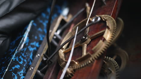 Close-up-of-a-brass-clockwork-from-an-antique-cuckoo-clock