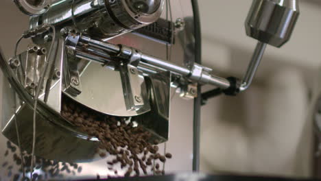 Organic-coffee-beans-falling-from-roasting-machine