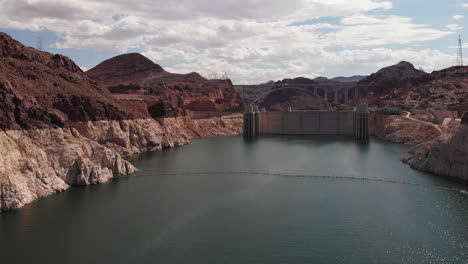 Drone-shot-moving-into-the-Hoover-Dam-during-the-day-over-Lake-Powell