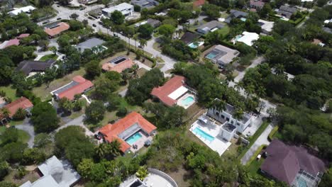 Aerial-Tilt-Reveal-of-a-Tropical-Suburb-with-Many-Pools