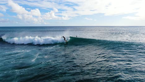 pull-out-shot-of-surfer-catching-and-riding-a-short-wave-in-hawaii