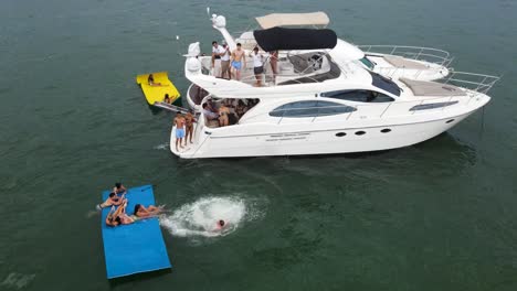 Person-doing-Backflip-off-Boat-while-Vacationing-in-Miami,-Florida---Aerial