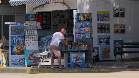 Local-artist-painting-outside-of-his-art-shop-in-Croatia