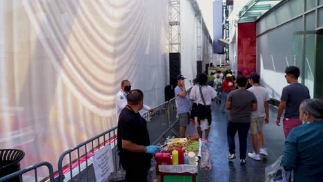 Tourists-pass-by-the-Oscars-Stage-being-constructed-on-a-Closed-Off-Hollywood-Boulevard