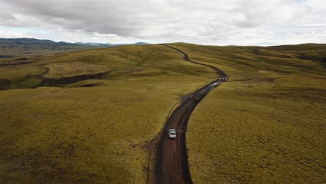 Drone-following-a-silver-car-on-a-Iceland-dirt-road-in-4k