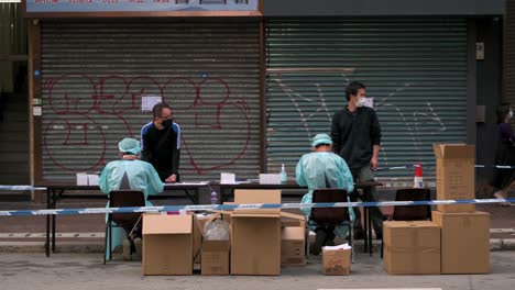 Health-workers-dressed-in-PPE-assist-residents-at-a-mobile-Covid-19-registration-testing-site-to-contain-the-spread-of-the-Coronavirus-variant-outbreak-in-Hong-Kong
