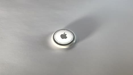 Close-up-shot-of-Apple-AirTag-on-white-background