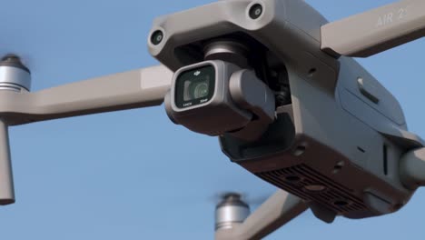 New-DJI-AIR-2S-drone-hovers-against-blue-sky,-close-up-shot