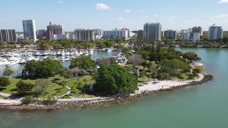 distant-spinning-aerial-of-the-entire-downtown-Sarasota-coastal-district-in-Sarasota,-Florida-as-visible-from-the-Gulf-of-Mexico