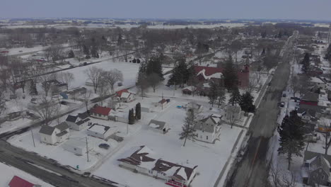 Drone-aerial-shot-over-a-small-midwest-town-in-the-winter-with-snow
