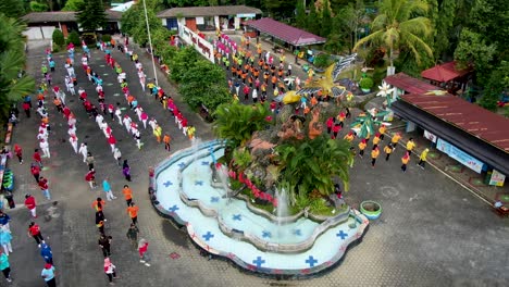 Colorful-group-of-people-exercising-in-Kyai-Langgeng-Park,-Magelang,-Indonesia