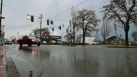 Few-Cars-Traveling-On-Wet-Road-After-Heavy-Rain-In-Downtown-Of-Coos-Bay-In-Oregon