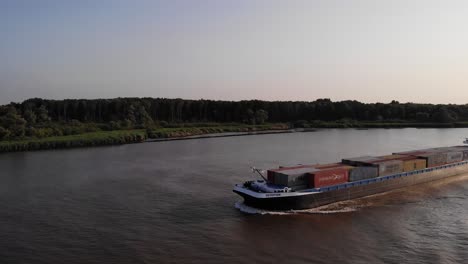Aerial-Port-And-Forward-Bow-View-Of-Cargo-Ship-Devotion-Going-Past-On-Oude-Maas-Near-Barendrecht